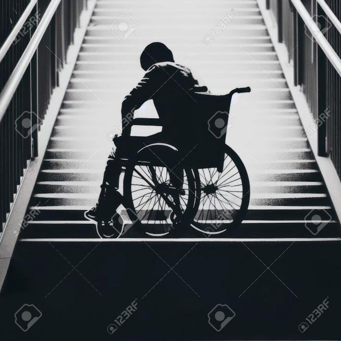 Individual in wheel chair looking at a large stair case.