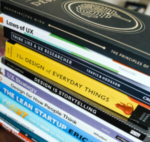 Web accessibility example of a stack of books about UX Design.