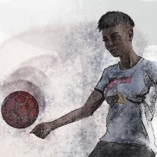 Female soccer player kicking the football.